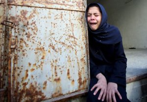 A relative of the 10 members of the Deeb family weeps at their funeral in Jabaliya refugee camp. The victims died in an Israeli strike on a a UN run school the previous day - Photograph: Mohammed Saber/EPA